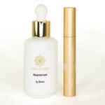 Haarserum in weißem Flakon mit goldener Kapuze, ideal für glänzendes, gepflegtes Haar.